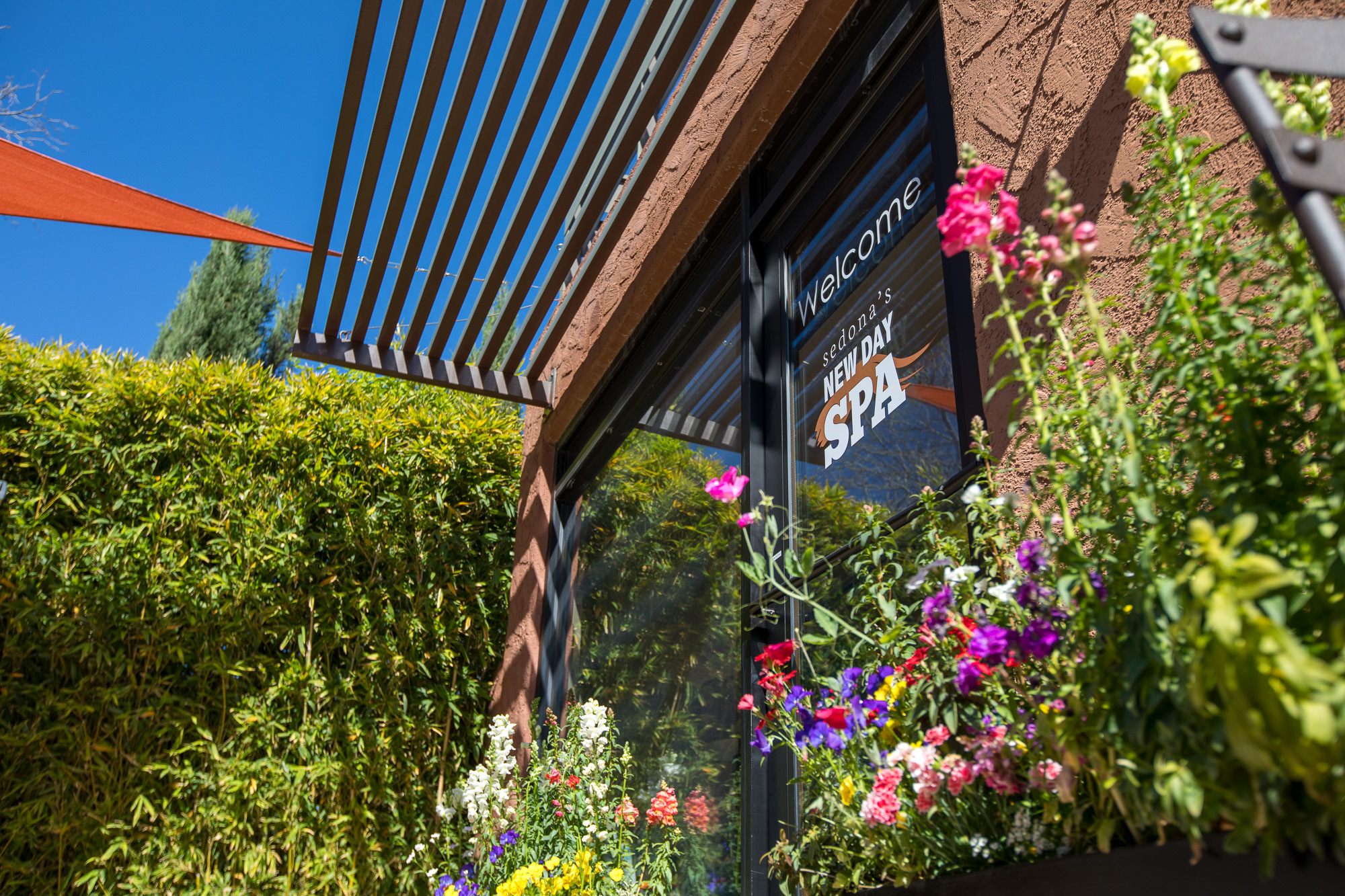 Sedona New Day Spa front door in Spring with bright colored flowers